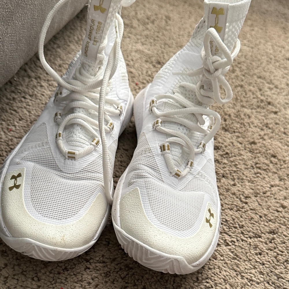 Gold and white under armour volleyball shoes